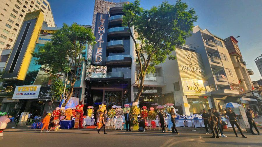 363 KTV LIMITED 街邊門頭，竪排 LIMITED 燈箱招牌與開業當天的花籃
