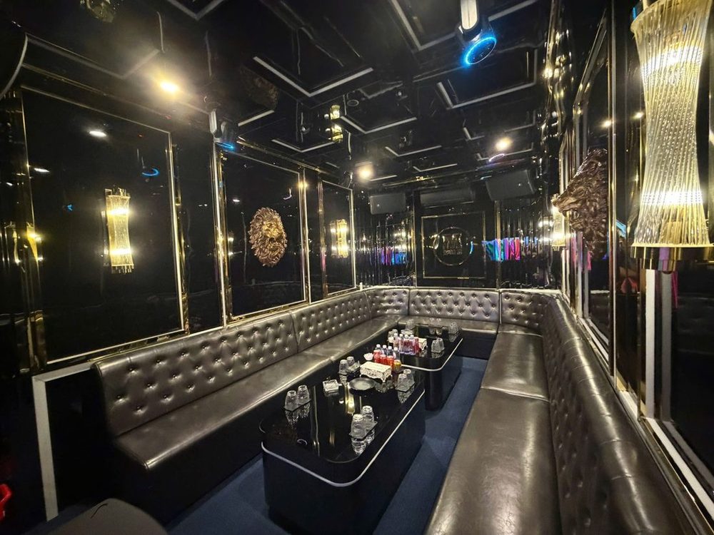 M SUITE 102 KTV 黑金包廂 · 銅色獅頭浮雕與金色流蘇壁燈